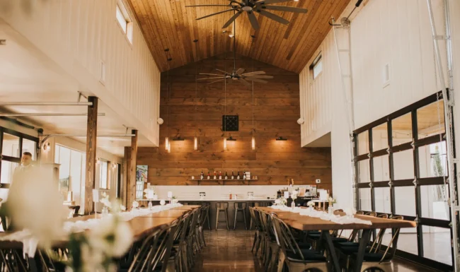 Walnut tables set for a wedding reception at Ghost Hill Cellars