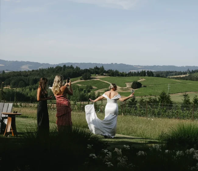 Bride with a glass of wine and an amazing view at Ghost Hill Cellars
